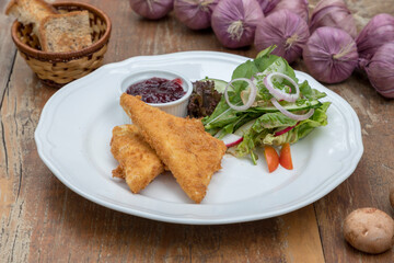 Baked feta cheese served with mixed salad and cranberry jam