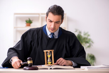 Young male judge in time management concept