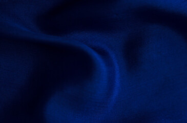 soft silk folds deep blue color - close up, decor and exclusive textured fabric background