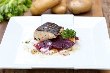 Pan-fried black cod on sautéed beetroot and potatoes with horseradish cream 