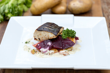 Pan-fried black cod on sautéed beetroot and potatoes with horseradish cream 