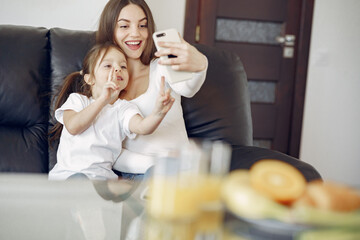 Beautiful woman with child. Woman in a white blouse. Mother's day.