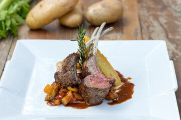 Grilled Australian lamb rack on ratatouille with potato gratin and Madeira jus