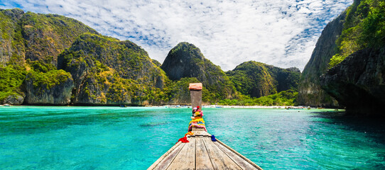 Traditional wooden boat in a picture perfect tropical bay on Koh Phi Phi Island, Thailand, Asia.