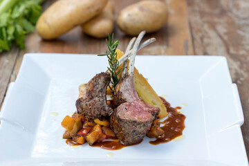 Grilled Australian lamb rack on ratatouille with potato gratin and Madeira jus