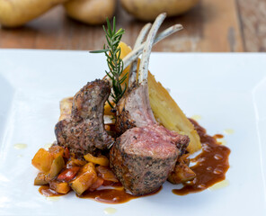 Grilled Australian lamb rack on ratatouille with potato gratin and Madeira jus
