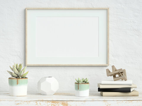 Mock up poster frame on white plaster wall with echeveria plants in pots, books and geometric objects  on old wooden table; landscape orientation; stylish frame mock up; 3d rendering, 3d illustration