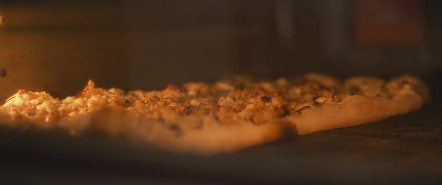 Time Lapse of a traditional al taglio pizza being baked in the oven.