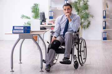 Young leg injured employee working in the office