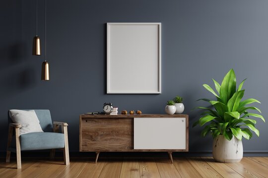 Poster mockup with vertical frames on empty dark wall in living room interior with blue velvet armchair.