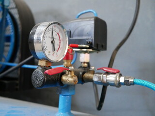 closeup of air compressor system in garage.