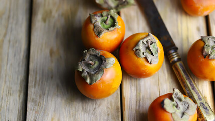 Persimmon on a wooden surface.