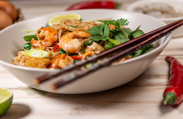 pad thai noodles with prawns on a old withe table 
