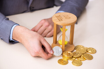 Young man earning money via Internet in time management concept