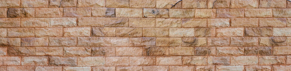 Brick wall of colorful color, wide panorama of masonry