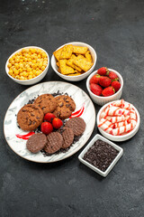 front view yummy choco biscuits with different snacks on dark background cookies tea sweet
