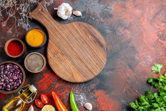 Dinner background fallen oil bottle beans cutting board and different spices stock image