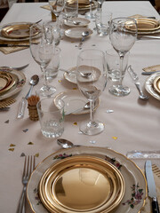 Holiday table with golden plate and sparkles
