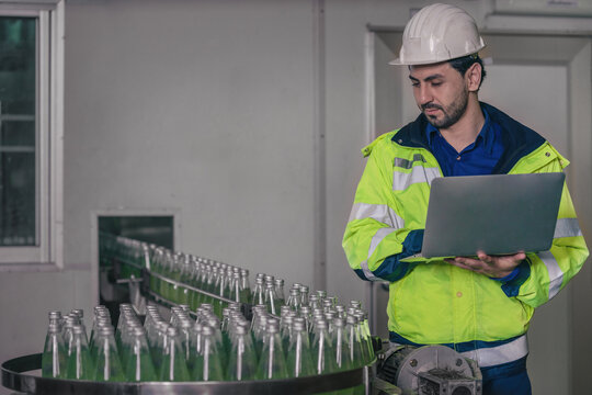 beverage factory production line engineer checking production line