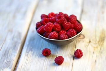Fresh juicy raspberries in a bowl. Dessert berry raspberry.