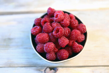 Fresh juicy raspberries in a bowl. Dessert berry raspberry.