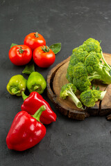 top view fresh broccoli with tomatoes and bell-peppers on dark floor ripe salad color