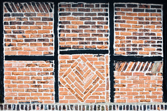Brickwork and black timber frame pattern in an historic Tudor building Faversham Kent England. - Powered by Adobe