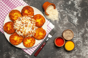 top view tasty fried cutlets with cooked rice on dark floor rissole meat dish