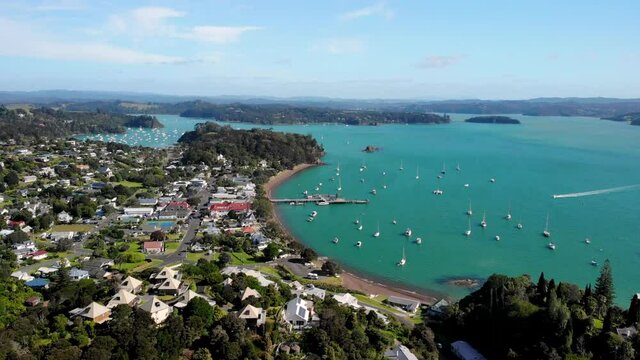Beautiful summer sunny day in Russell, New Zealand. Aerial birds eye view of historic village, small port, anchored yachts.