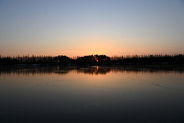 the sunset of a lake park