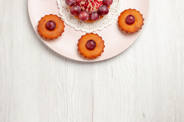 top view delicious cakes with grapes inside plate on white desk pie dessert cake