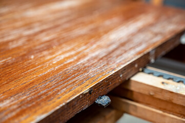 Selective focus on mechanism and gap for adding an additional leaf to an expandable kitchen table