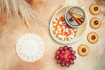 top view little cookies with cup of tea on light background sweet biscuit cake