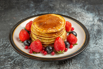 front view yummy pancakes with fruits and honey on a light background breakfast sweet fruit