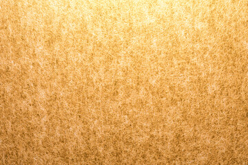 光が当たった金色の紙
