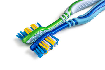 Two toothbrushes, green and blue on a white background