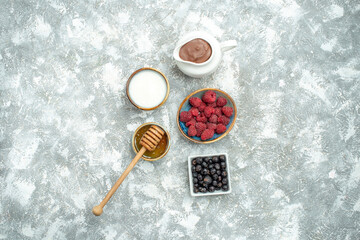 top view fresh raspberries with honey on white background color photo fruit berry