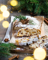Traditional German cake Stollen, fruit bread with dried fruit, covered with powdered icing sugar. Christmas cake, Weihnachtsstollen, Christstollen. Selective focus