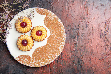 top view yummy little cookies inside plate on dark background cake sweet biscuit sugar