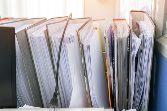 Business report blue stack binders folder for insert tax information paper document tag label and storage at offices sheles in organization management on busy desk office