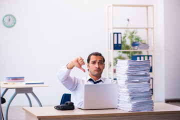 Naklejka premium Young male employee unhappy with excessive work