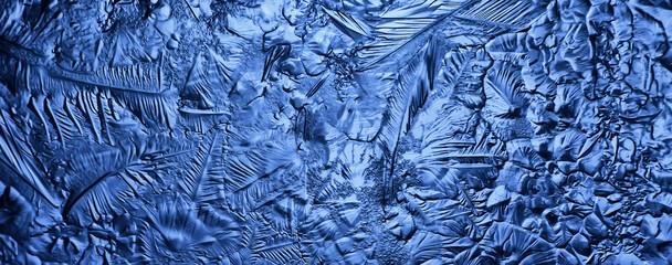 blue ice glass background, abstract texture of the surface of the ice on the glass, frozen seasonal water