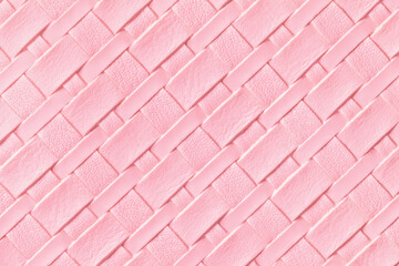Texture of light pink and rose leather background with wicker pattern, macro.