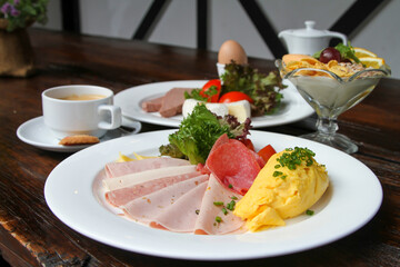 Breakfast table with different German breakfasts and coffee and tea