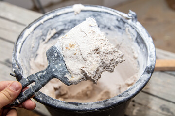 A worker mixes the plaster mix