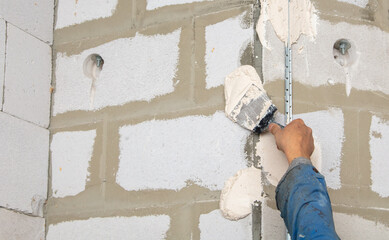 A worker plasters the walls