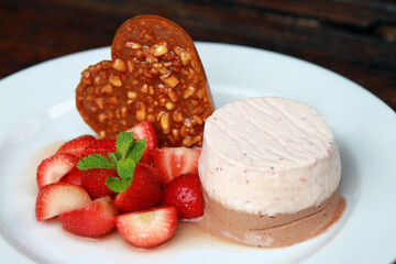Strawberry parfait with fresh fruits and heart shaped brittle