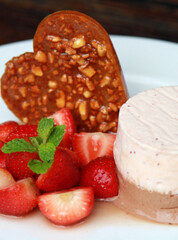 Strawberry parfait with fresh fruits and heart shaped brittle