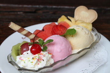 Fruit ice cream with fresh fruits, waffle and whipped cream