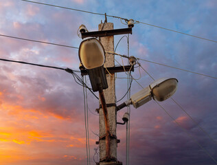 Electric pole with wires at sunset.